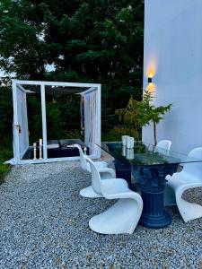 a table and some chairs and a table and a room at Awangarda in Trzciel
