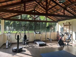 a gym with exercise equipment and a large window at Pousada Arara in Valença