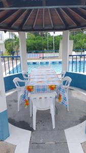 a table and chairs under a gazebo near the water at Finca Villa Hayde in Flandes