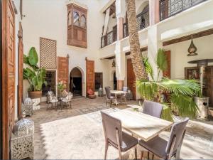 an outdoor patio with a table and chairs at Riad Zamzam & Spa in Marrakesh
