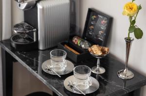 a table with three wine glasses and a vase at Hotel RECEPTION in Tel Aviv +22 photos