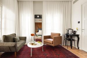 a living room with a couch and two chairs and a table at Hotel RECEPTION in Tel Aviv