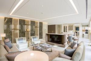 a living room with a large couch and a television at Vivienda Hada Residences in Riyadh