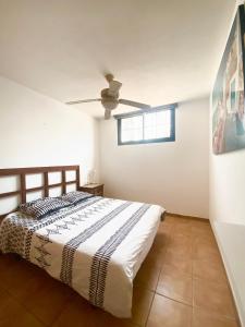 a bedroom with a bed and a ceiling fan at Atlantic Breeze House in Corralejo