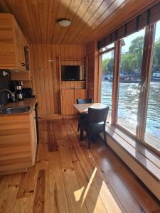 a kitchen and dining room with a table and chairs at Mar&Mar Houseboat Studio in Amsterdam +22 photos