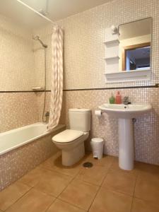 a bathroom with a toilet and a sink at Atlantic Breeze House in Corralejo