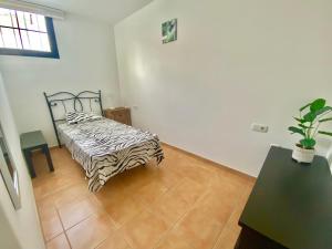 a bedroom with a zebra print bed in a room at Atlantic Breeze House in Corralejo +2 photos