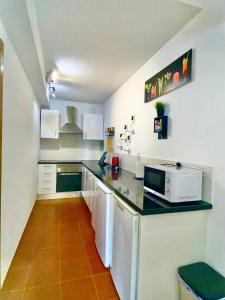 a kitchen with a counter top with a microwave at Atlantic Breeze House in Corralejo