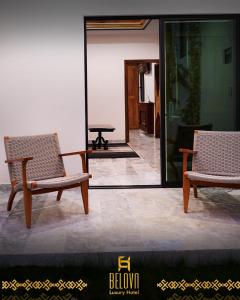 two chairs sitting in a room with a mirror at Belova Luxury Hotel, San Cristobal de las Casas in San Cristóbal de Las Casas +202 photos