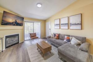 a living room with a couch and a fireplace at 3BR Apartment in Seven Hills, Near Hospital in Henderson