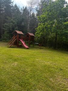 a playground with a slide in a yard at Dom z dużym tarasem nad jeziorem na wyłączność in Krasnopol