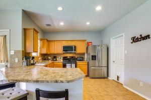 a kitchen with wooden cabinets and a granite counter top at Fish and Hike Pet-Friendly Humble Home with Yard in Humble