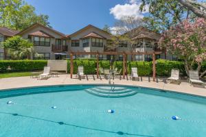 a swimming pool in front of a house at Harbour Oaks #310 in Saint Simons Island