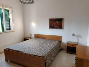 a bedroom with a bed and a table and a window at Villette Mar Ionio in Nardò +32 photos