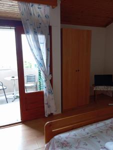 a bedroom with a door open to a balcony at Apartment Stella in Murter