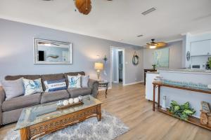 a living room with a couch and a table at Ocean Walk A1 in Saint Simons