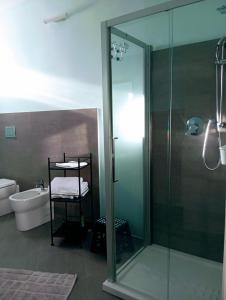 a bathroom with a glass shower and a toilet at Poggio Capriolo in Acquapendente +8 photos