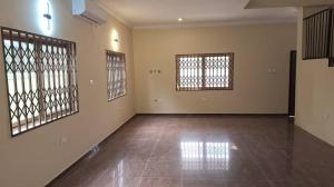 an empty room with two windows and a tiled floor at Zoey Casa in Accra