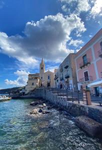 a group of buildings next to a body of water at Via Roma 55 in Lipari