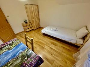 a small room with a bed and a dresser in it at Dom na zboczu góry in Brenna +34 photos