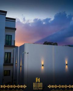a white building with the sunset in the background at Belova Luxury Hotel, San Cristobal de las Casas in San Cristóbal de Las Casas