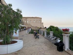 a walkway with chairs and a building on a hill at MareMy Vasto Centro in Vasto