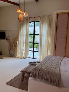 a bedroom with a bed and a large window at Villa Privada con Piscina - Playas del Atlantico in Tubará +22 photos