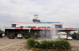 a gas station with a fountain in front of it at Hotel Anmol and Resort in Ghāt Bilod