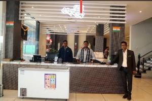 a group of men standing at a counter in a store at Hotel Anmol and Resort in Ghāt Bilod
