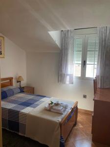 a bedroom with a bed with a blue and white at Casa Rural La Abuela Obdulia in Piornal