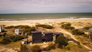 an aerial view of a beach with a house at ALMAR Cabaña Boutique Frente al Mar in La Pedrera