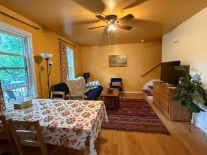 a living room with a table and a ceiling fan at Beautiful 2-Bedroom, 2-Bath Townhouse in Boston