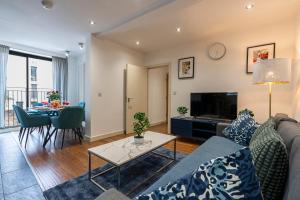 a living room with a couch and a table at Brick Lane Apartments in London