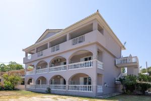 a large white building with balconies at Palm Studios, 350m from Agios Sostis Beach, by ZanteWize in Zakynthos Town