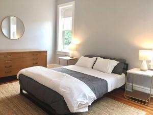a bedroom with a large bed and a mirror at Giraffe Properties in Clayton