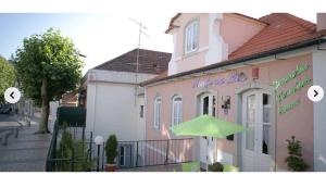 a green umbrella in front of a pink building at Monte da Lua in Sintra