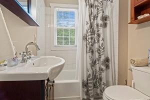 a bathroom with a sink and a shower curtain at # Stay At Our Tasteful, Private, & Elegant Abode # in Devon +22 photos