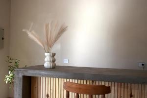 a table with a vase with feathers in it at Altos del Peñón in El Peñón