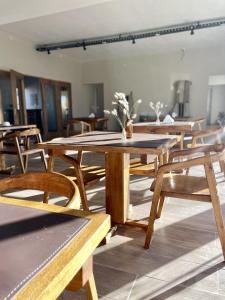 a group of wooden tables and chairs in a room at Altos del Peñón in El Peñón +41 photos