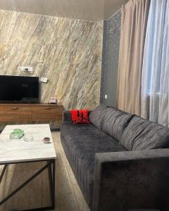 a living room with a couch and a table at Apart erevan 12 