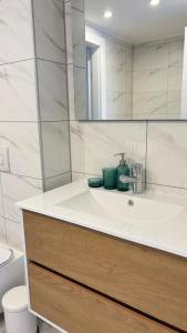 a bathroom with a sink and a mirror at Blue Bay in Netanya +39 photos