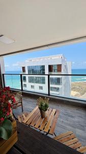a balcony with a table and a view of the ocean at Blue Bay in Netanya
