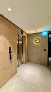 a lobby with a elevator and a sign on the wall at Blue Bay in Netanya