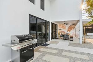 a kitchen with a stove and a patio at Waterfall Pool, Kids' Paradise, Quiet Beaches in Playa Grande +22 photos