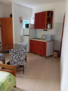 a kitchen with a table and a kitchen with a counter top at Apartment Stella in Murter