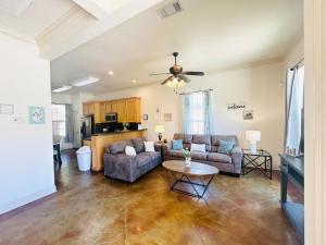 a living room with two couches and a table at Villa 6 in Hammond