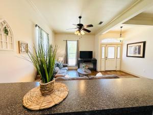 a living room with a couch and a ceiling fan at Villa 6 in Hammond