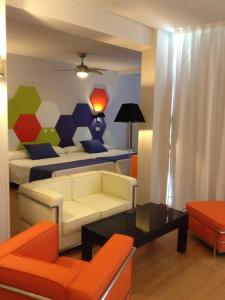 a living room with a couch and a bed at Evenia Zoraida Resort in Roquetas de Mar +18 photos