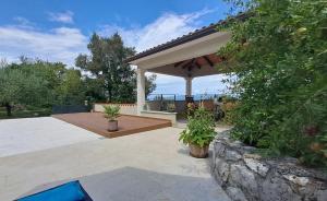 a pavilion with potted plants on a patio at ISTRIAN vibeS in Drenje