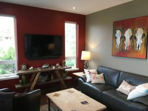 a living room with a couch and a tv at Barnwood Chateau With 2 Master Suites Hot Tub in Salida